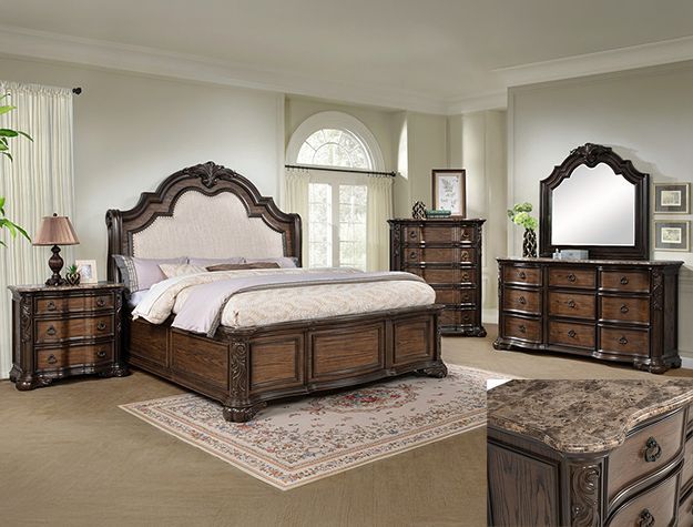 Elegant dark wood bedroom set with ornate bed, dresser, nightstand, mirror, and arched window.