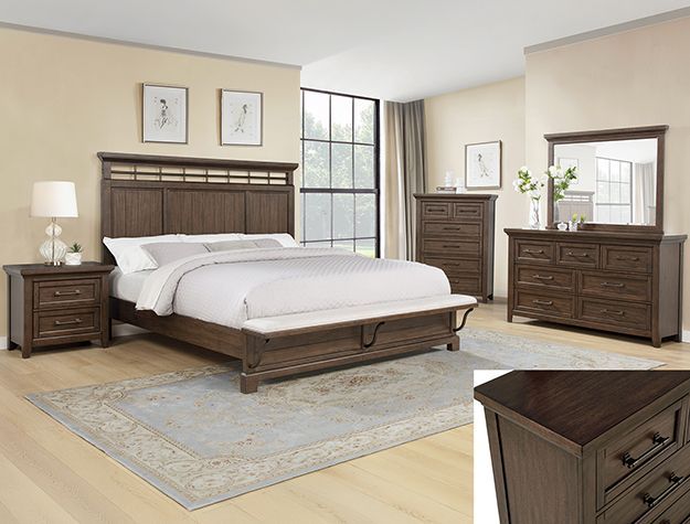 Elegant bedroom with dark wood bed, dresser, nightstand, mirror, and light rug on hardwood floor.