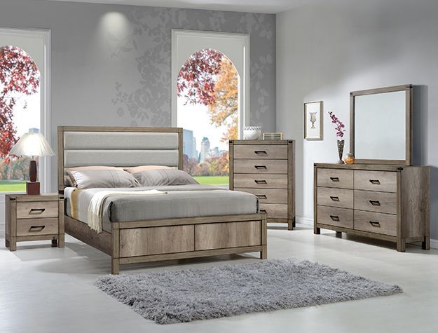 Modern bedroom set with wooden bed, dressers, nightstand, mirror, and gray rug in a bright room