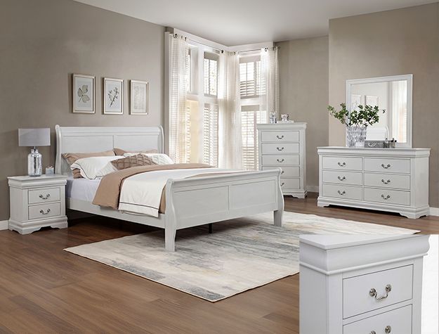 Bright bedroom with white furniture, a bed, dresser, nightstand, mirror, and wood floor
