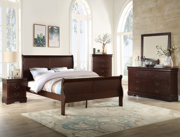 Elegant bedroom with dark wood bed, matching dresser, nightstand, and tall arched windows
