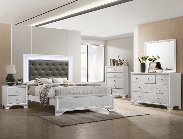 Elegant white bedroom with tufted bed, dresser, nightstands, and bench in a bright modern room