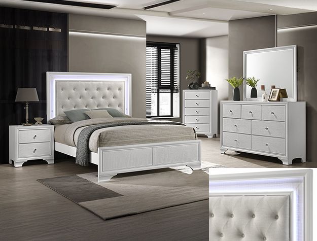 Modern white bedroom set with tufted bed, nightstands, dresser, and mirrored wall decor