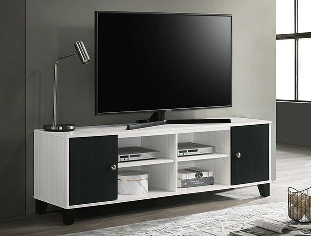 Modern black-and-white TV stand with a flat-screen TV and small lamp in a living room.