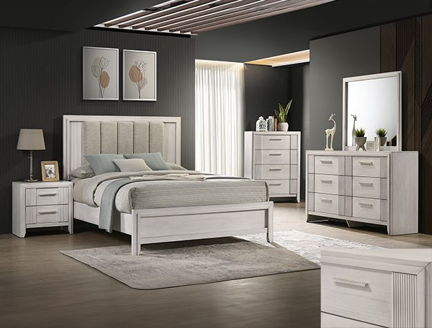Modern white bedroom set with bed, nightstands, dresser, mirror, and rug in a dark room