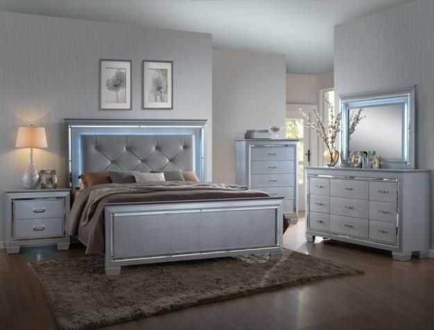 Elegant gray bedroom with tufted bed, bedside lamps, dresser, and matching decor