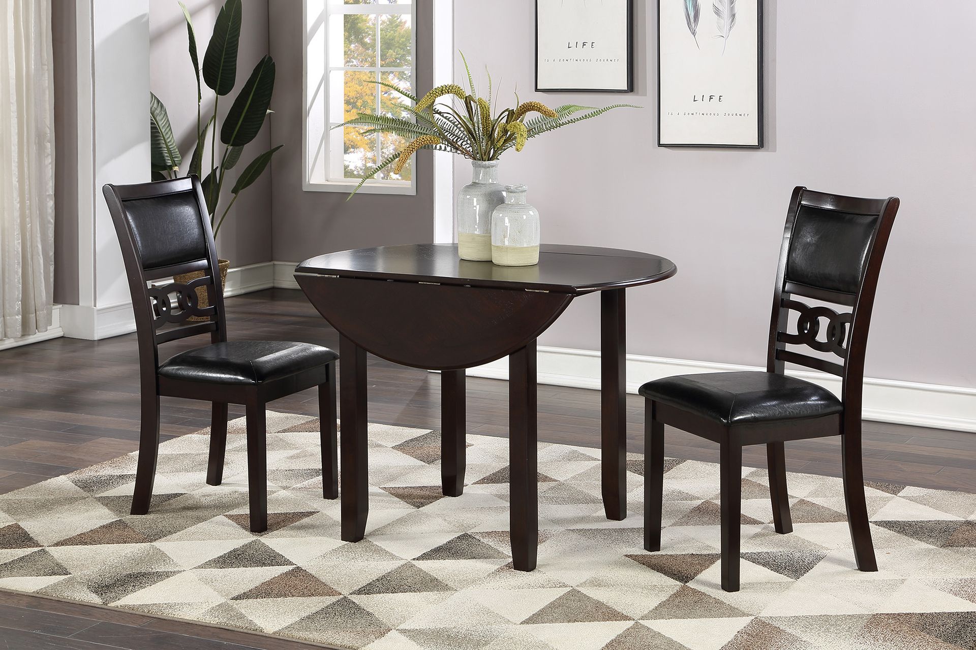 Dark wood dining set with two chairs, round table, and vase in a bright room with patterned rug