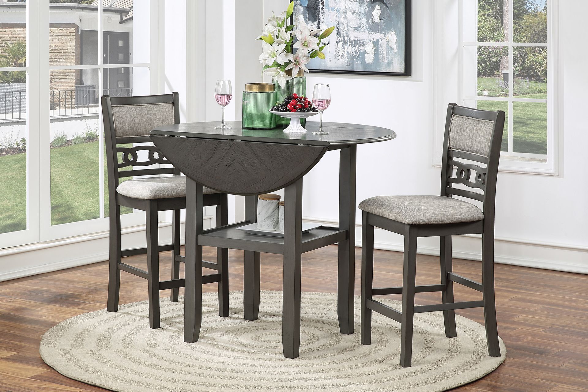 Dark wood dining set with four chairs around a round table in a bright room