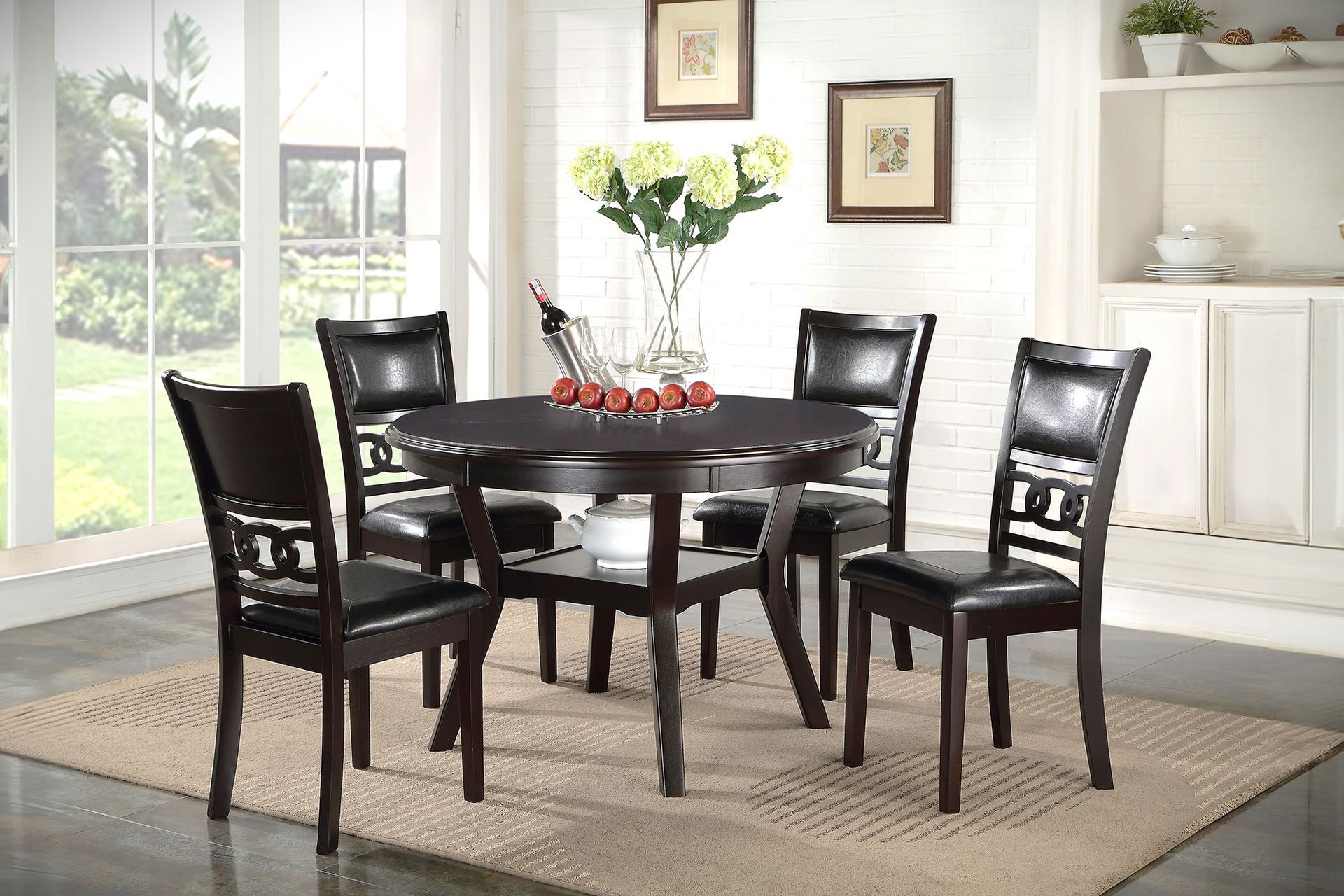 Dark wood dining table and chairs in a bright room with a vase of flowers and built-in shelves