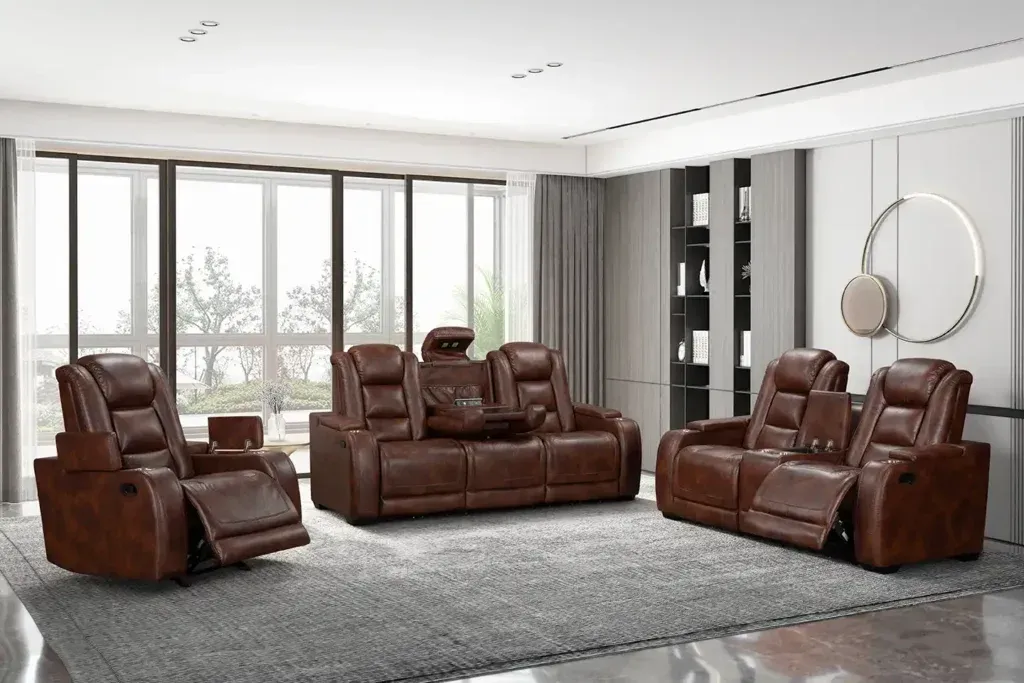 Brown leather reclining sofa set in a bright modern living room with large windows and gray rug