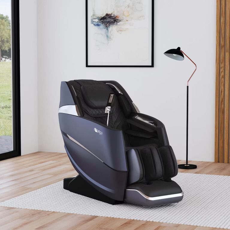 Modern black massage chair in a bright minimalist room with wood floors and a floor lamp.