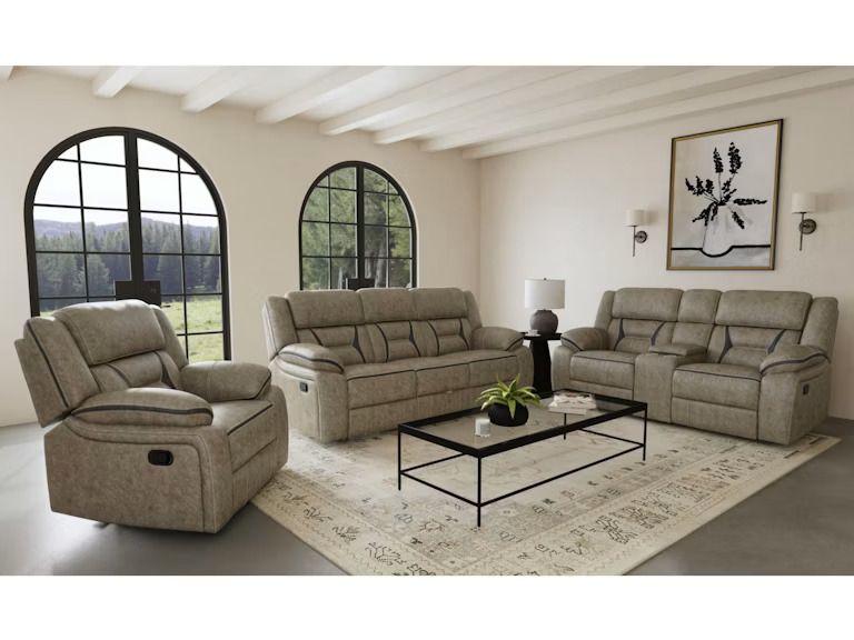 Neutral living room with beige sofa set, black coffee table, arched windows, and patterned rug.