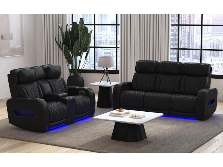 Modern living room with two black recliner sofas, blue LED lighting, and a white coffee table