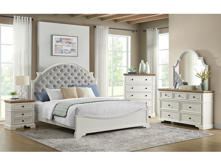 White upholstered bed and matching bedroom furniture in a bright, airy modern bedroom