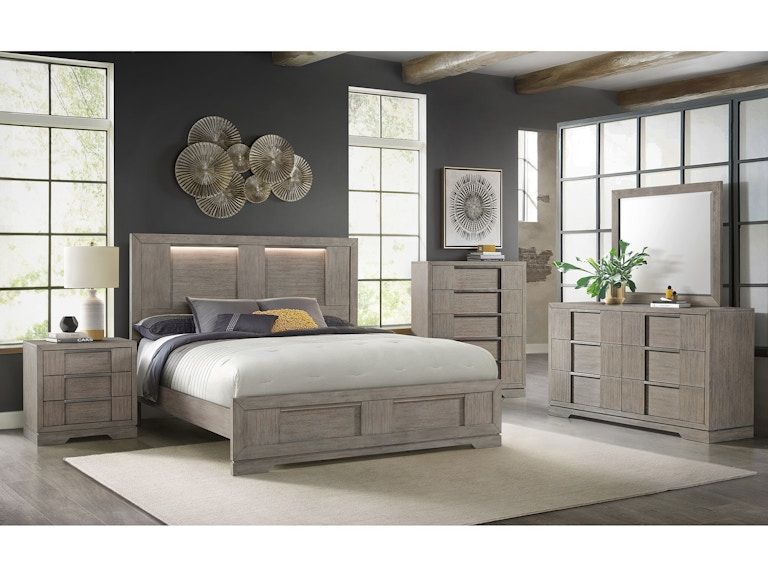 Modern gray bedroom with a large bed, matching nightstands and dresser, and soft natural light through windows