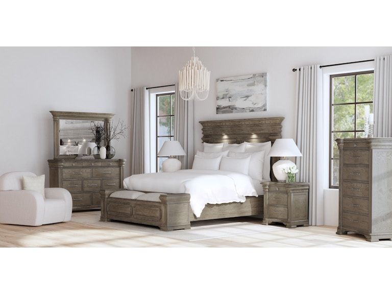 Bright neutral bedroom with a white bed, wooden furniture, and large windows