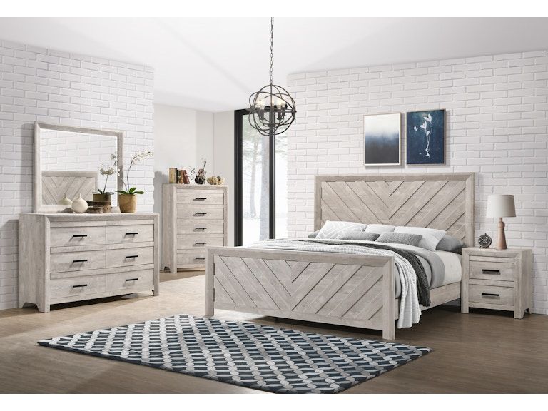 Bright white bedroom set with bed, dressers, mirror, nightstands, and blue patterned rug