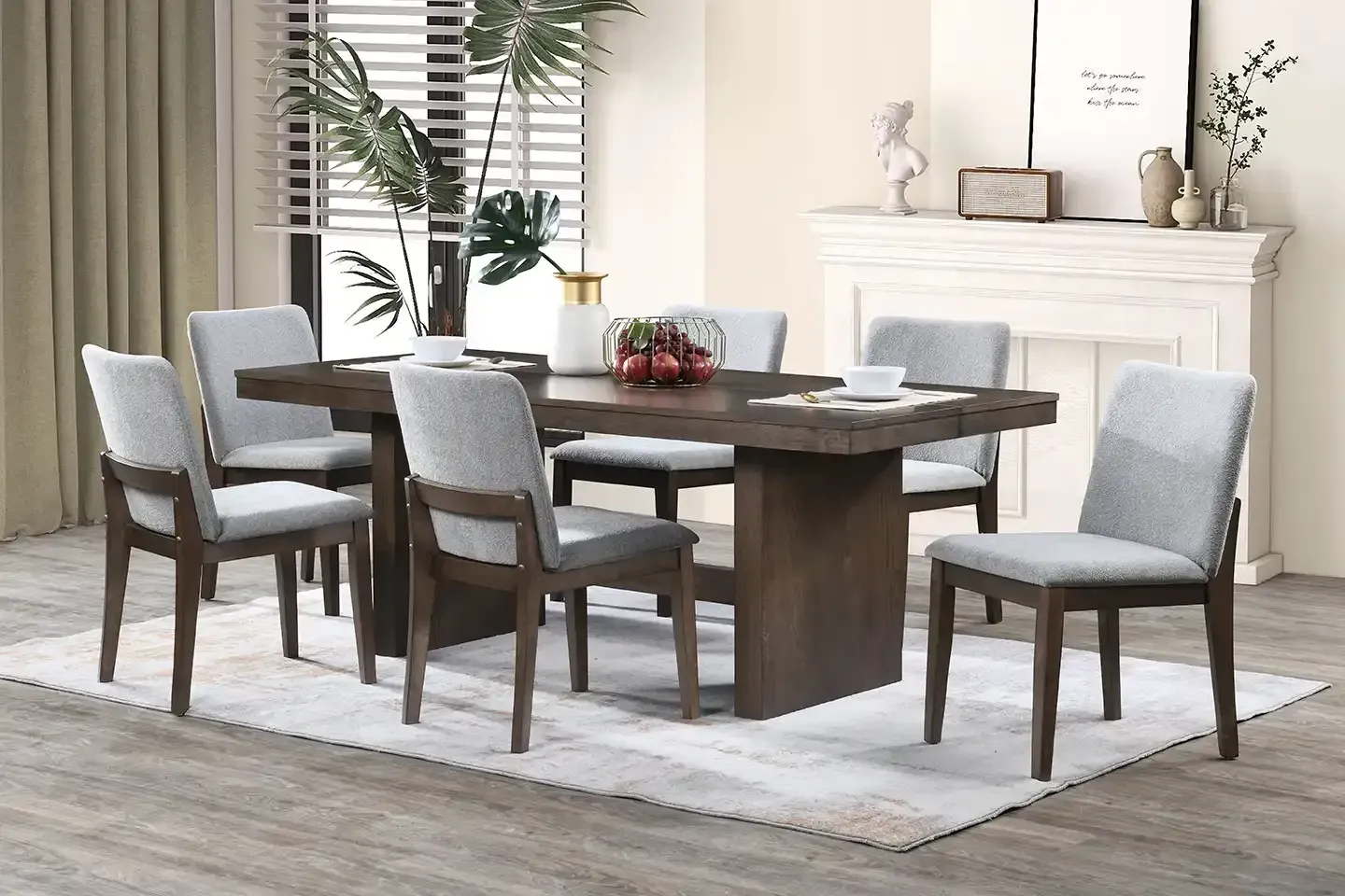 Dining room with dark wood table, six gray chairs, and a white fireplace in a bright, modern interior