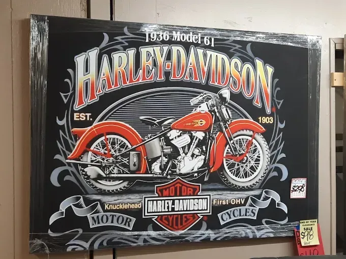 Harley-Davidson vintage-style wall art with a red motorcycle on a black background