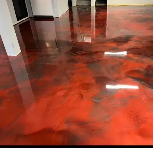 Glossy red and black epoxy floor in a room.