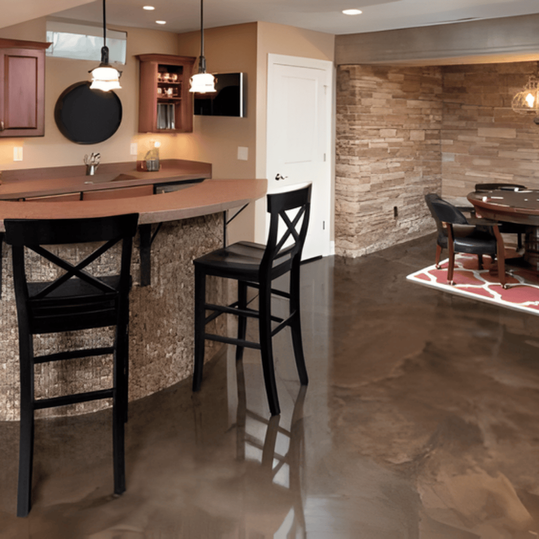 Bar with black stools and glossy floor in a basement with brick wall and dining area.