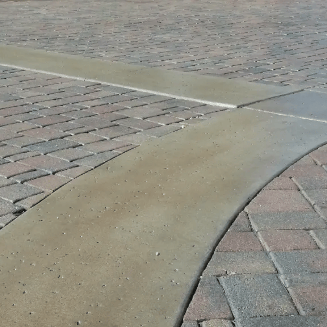 Brick pavers with concrete joints in a driveway.