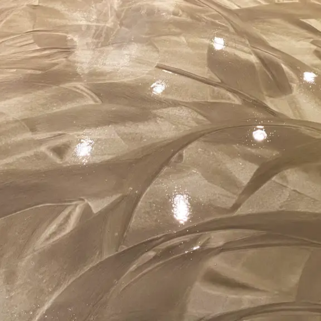 Shiny, swirled, beige epoxy floor with multiple light reflections.