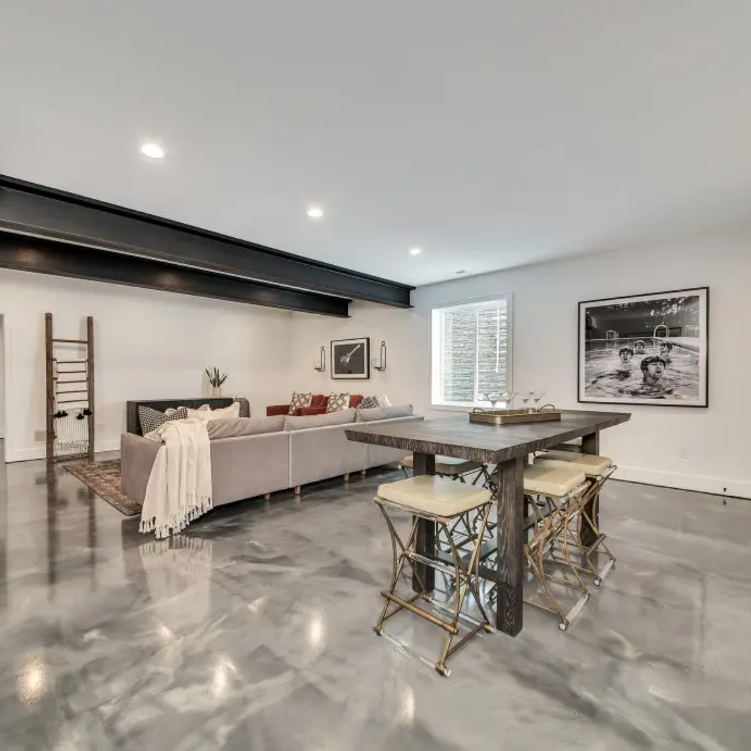 Modern living room with bar, sofa, art, and metallic flooring.