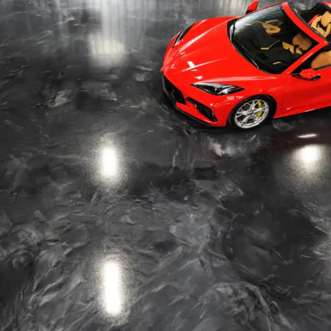 Red sports car on a shiny, dark gray epoxy floor.
