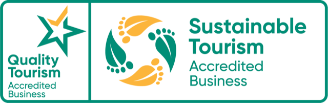 Quality Tourism and Sustainable Tourism Accredited Business logos in green, teal, and gold