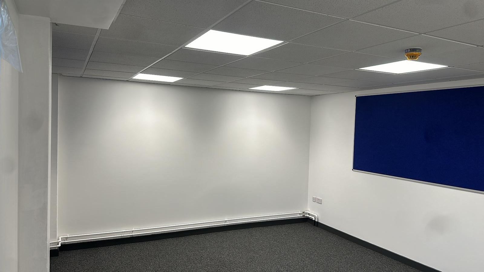 Freshly painted wall with tape and jointing