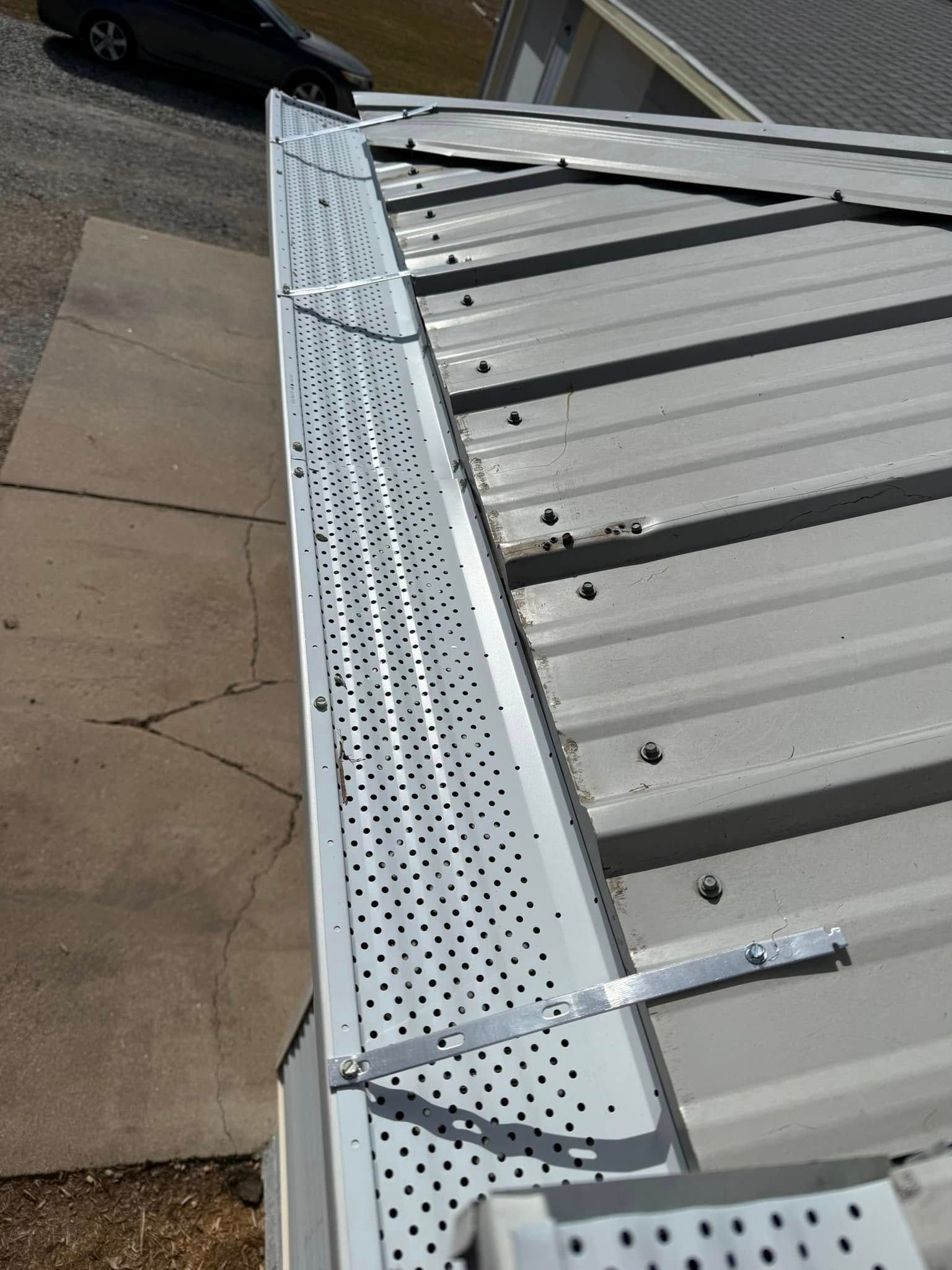 Metal roof with installed gutter guards.
