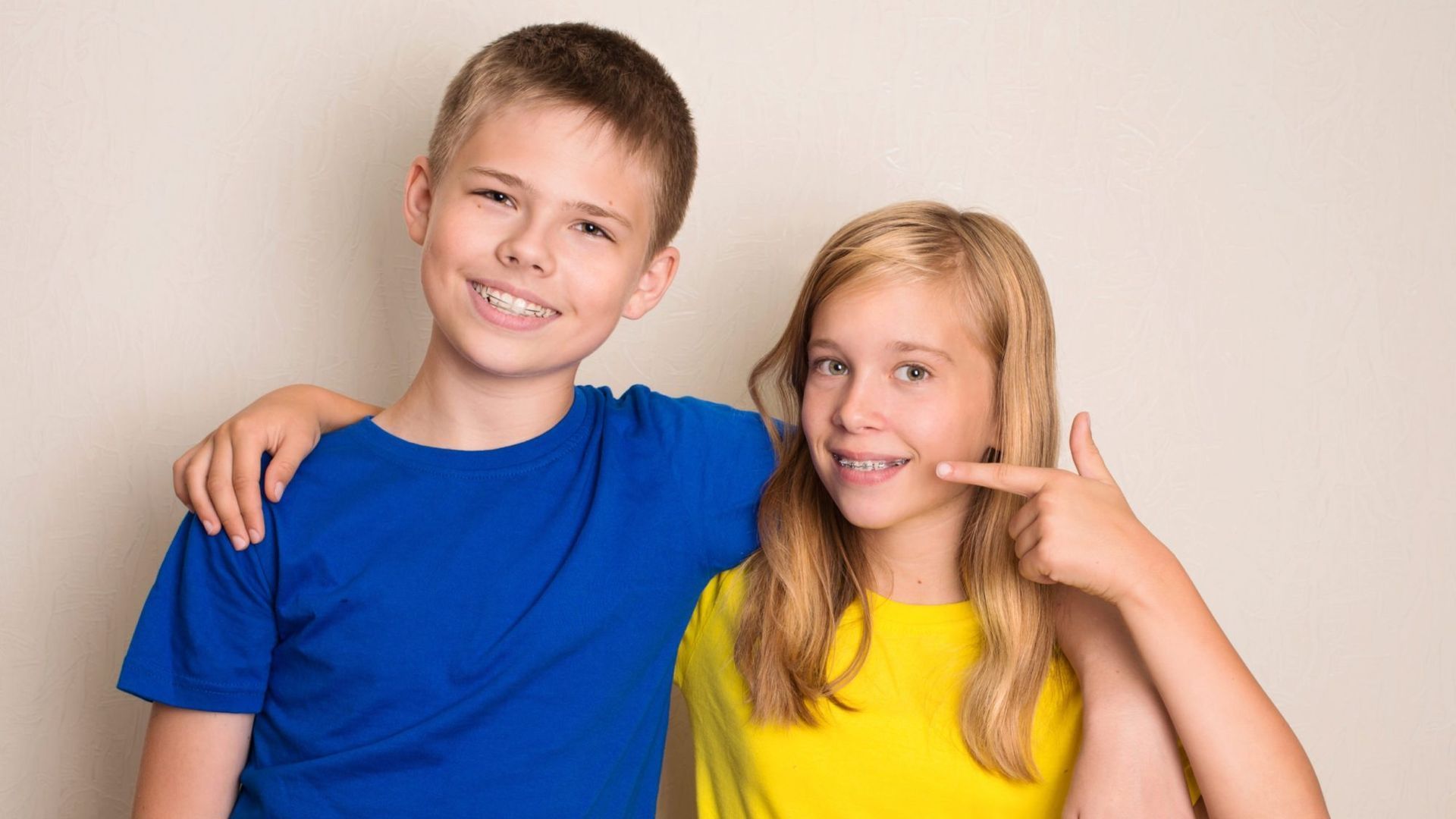 a boy and a girl with braces on their teeth