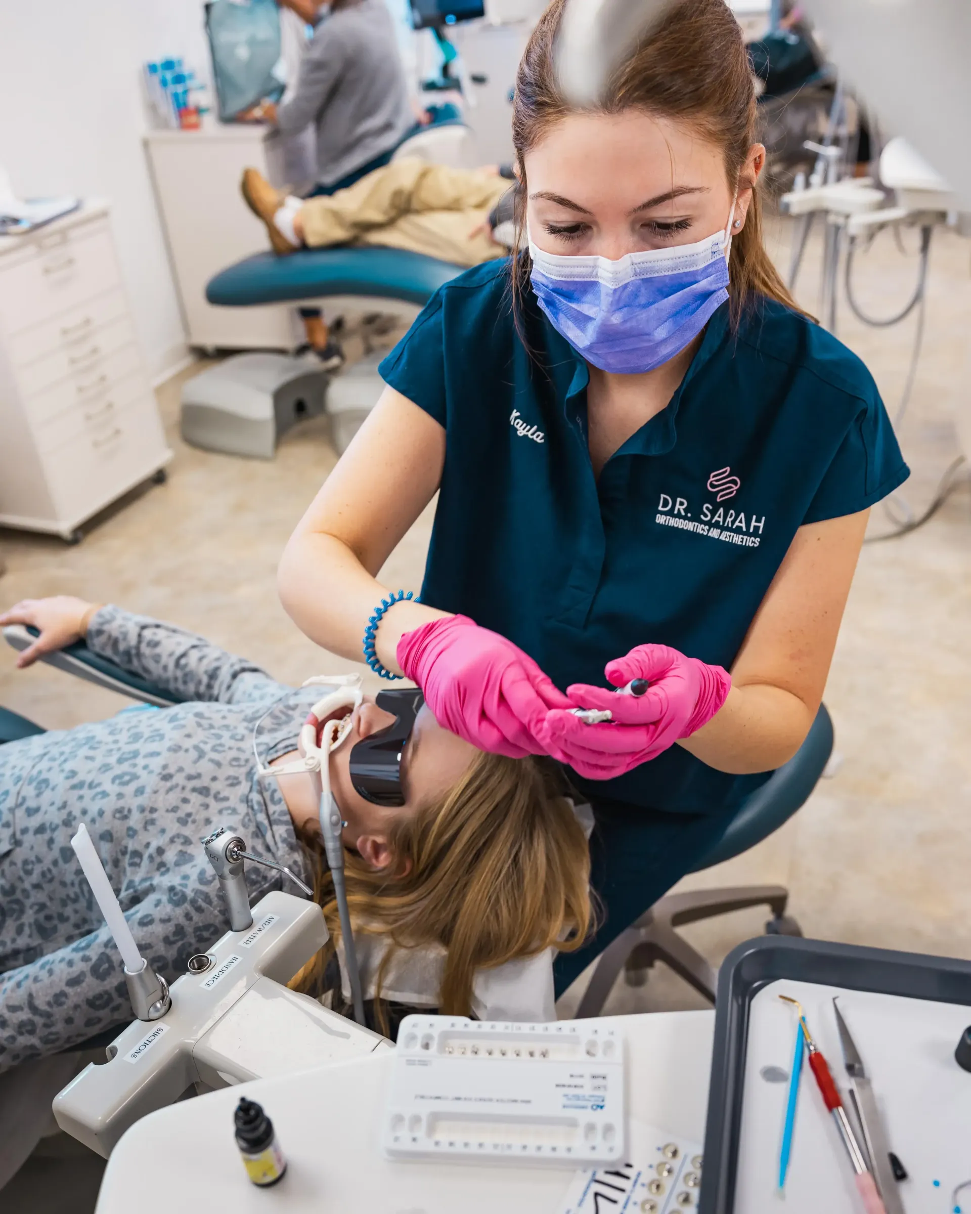 Orthodontic assistant treating a patient at Dr. Sarah Orthodontics.