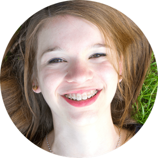 kid smiling with clear braces
