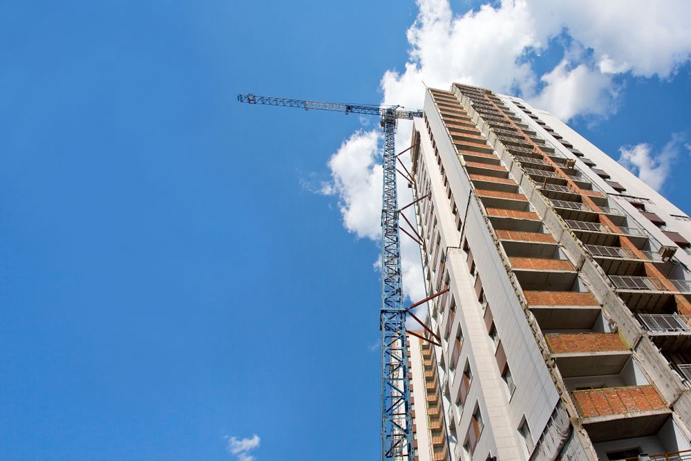 Construction of a Tall Building With a Blue Sky and White Clouds — Rowal Constructions in Warners Bay, NSW