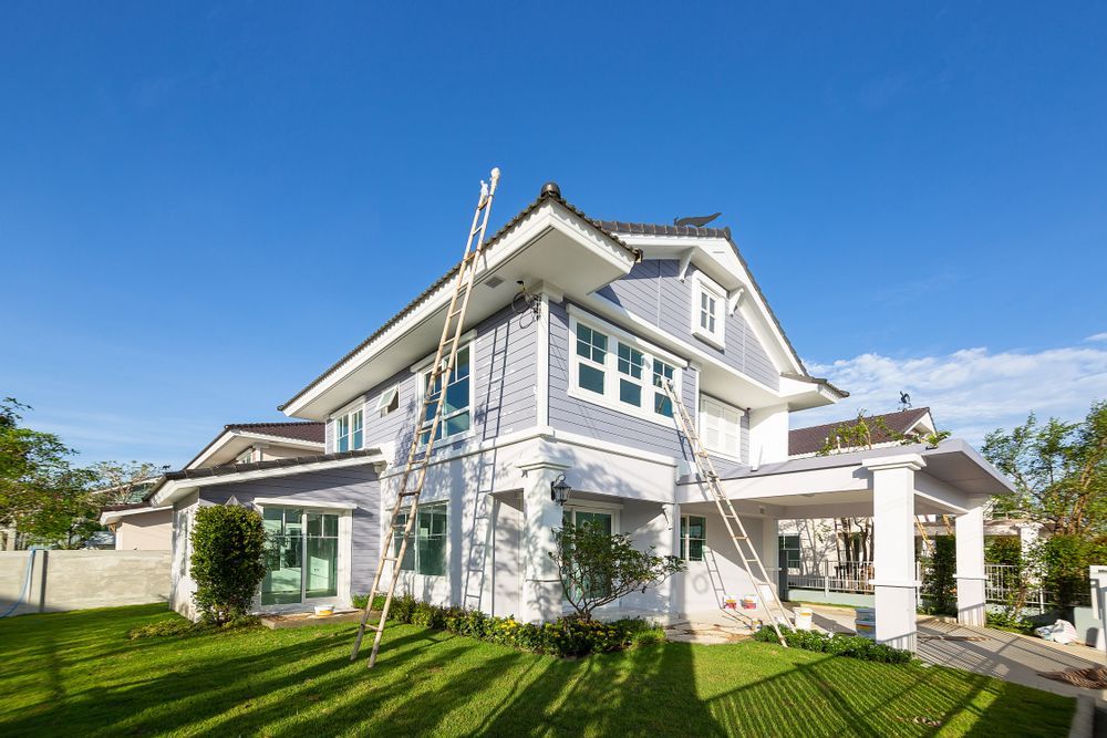 Two-story House With Blue and White Siding, Ladders — Rowal Constructions in New Lambton, NSW