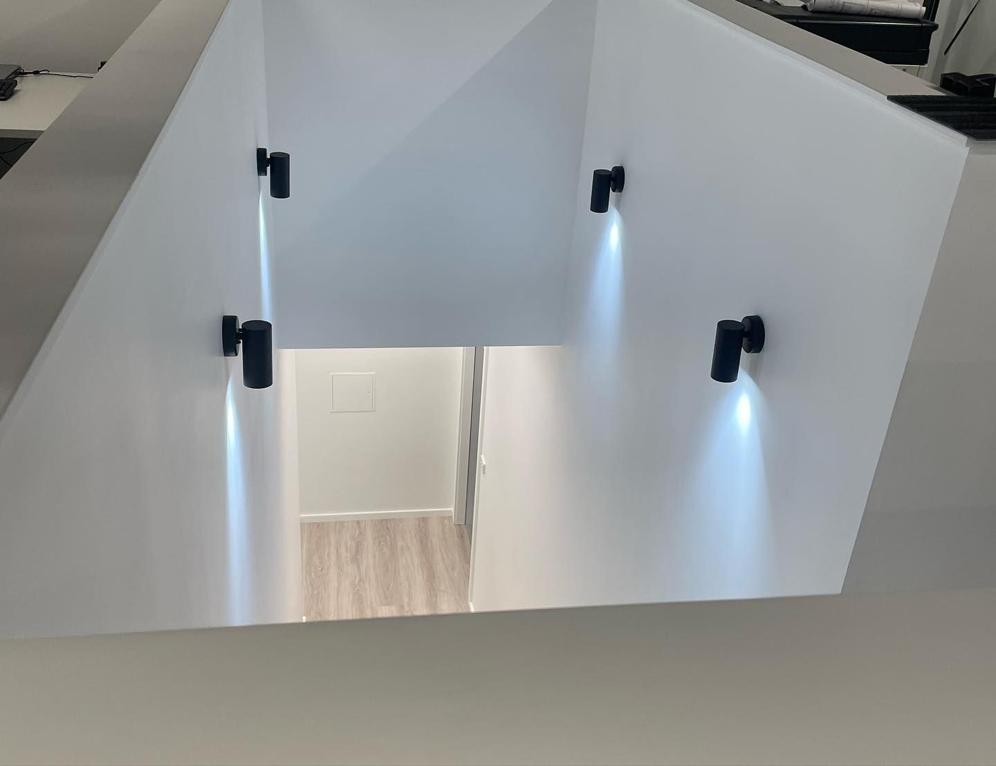 White Angled Ceiling With Four Black Spotlights Illuminating a Hallway — Rowal Constructions in Merewether, NSW