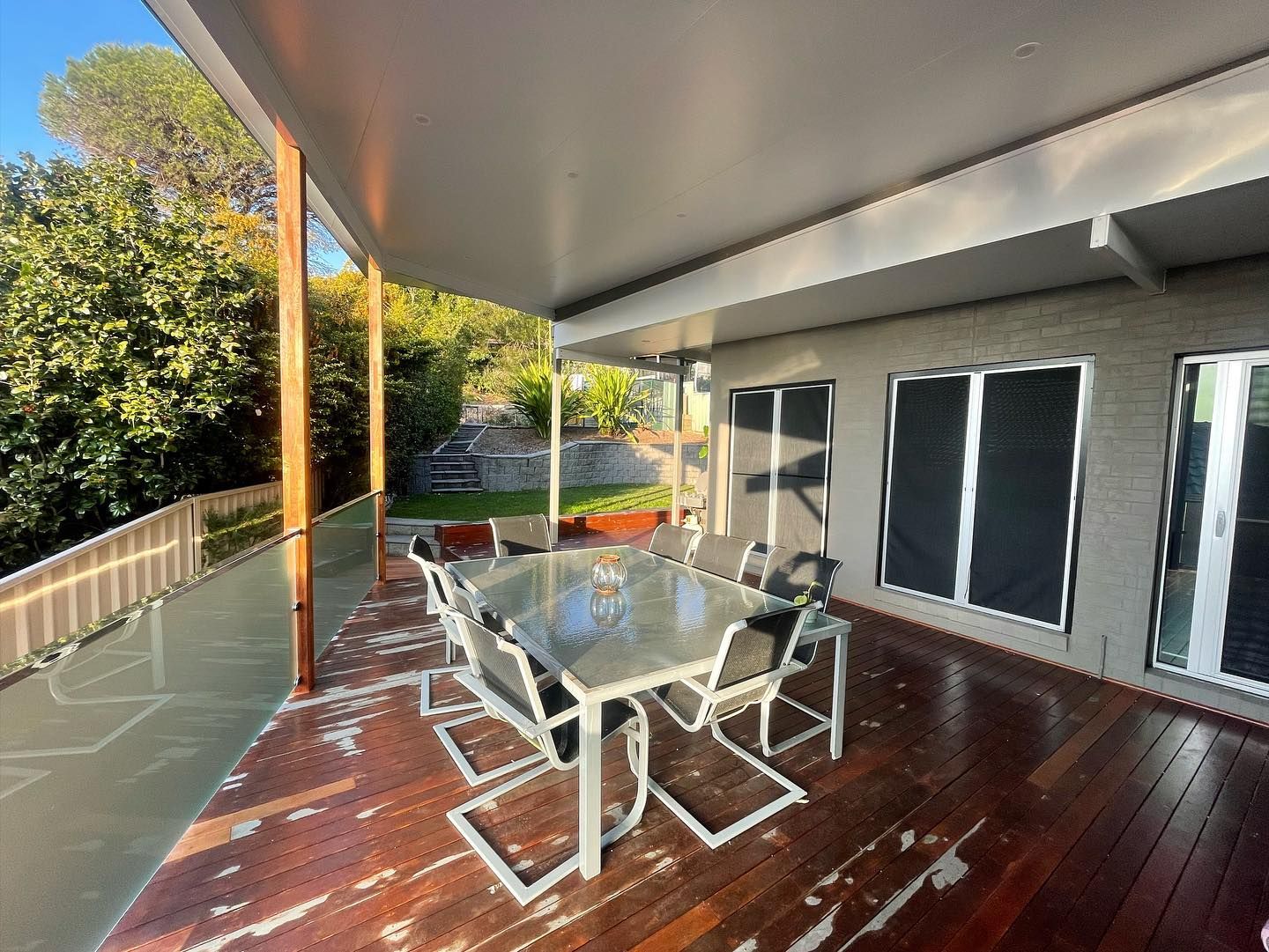 Outdoor Patio With Dining Table and Chairs, Overlooking a Backyard With Trees — Rowal Constructions in Mayfield, NSW