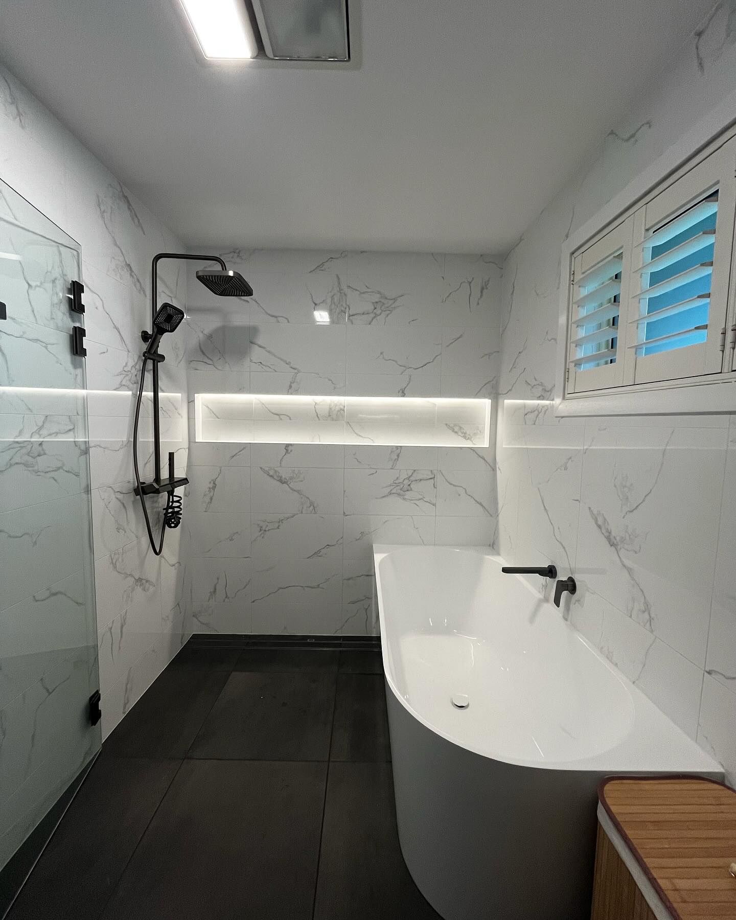 Modern Bathroom With Marble Tile Walls, Black Fixtures, Shower — Rowal Constructions in Mayfield, NSW