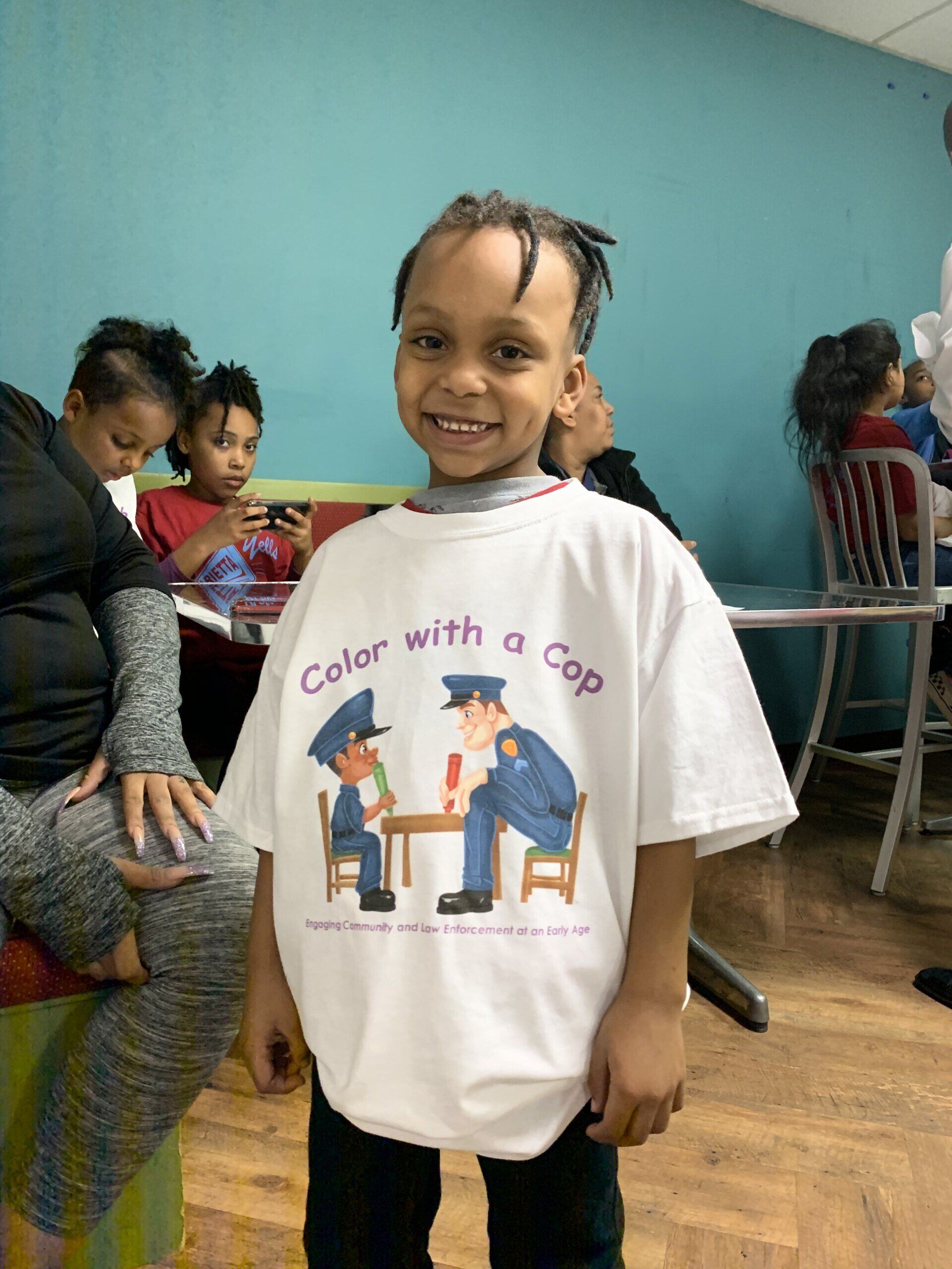 A young boy wearing a shirt that says 