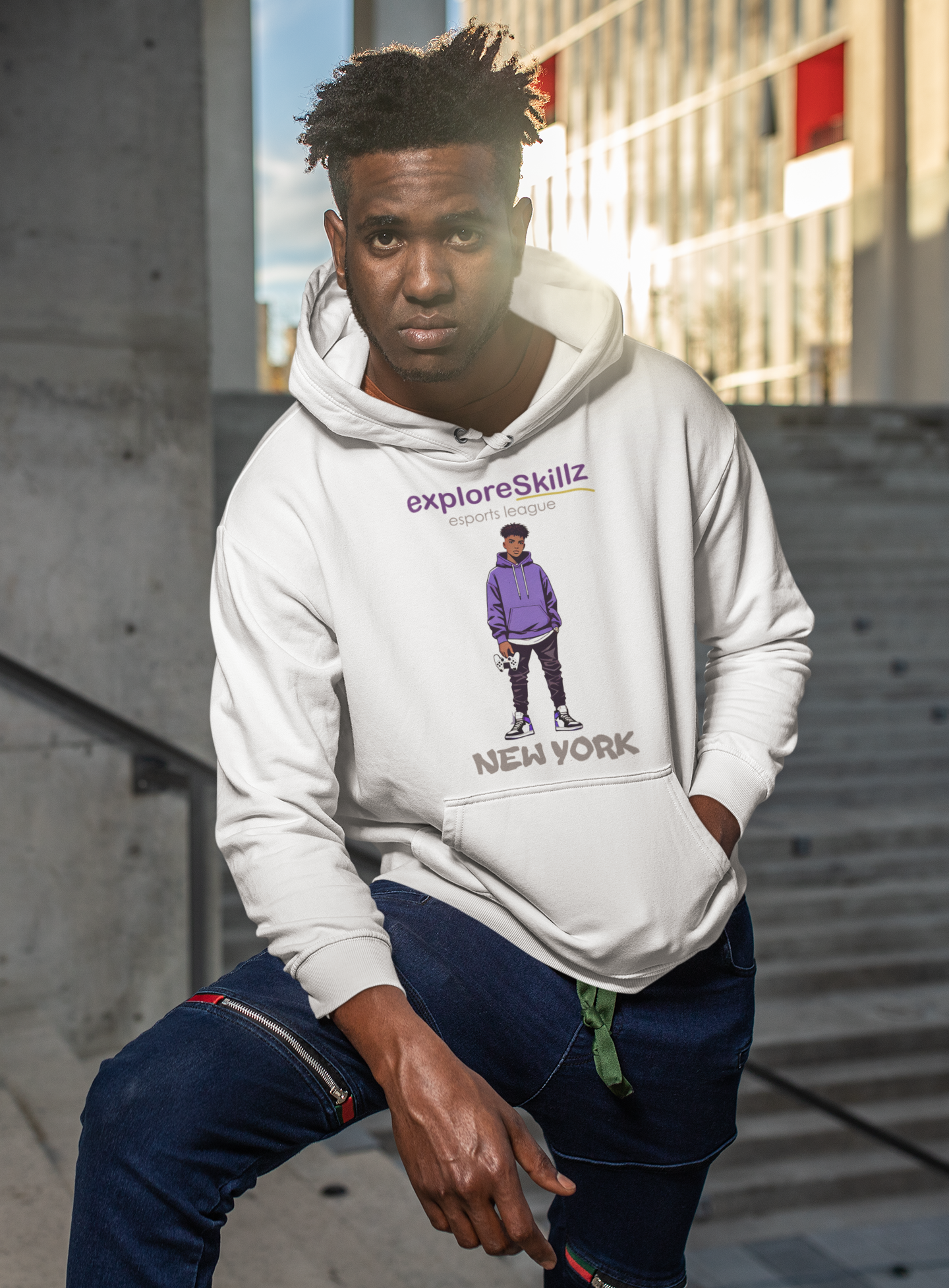A man wearing a white hoodie is sitting on a set of stairs.