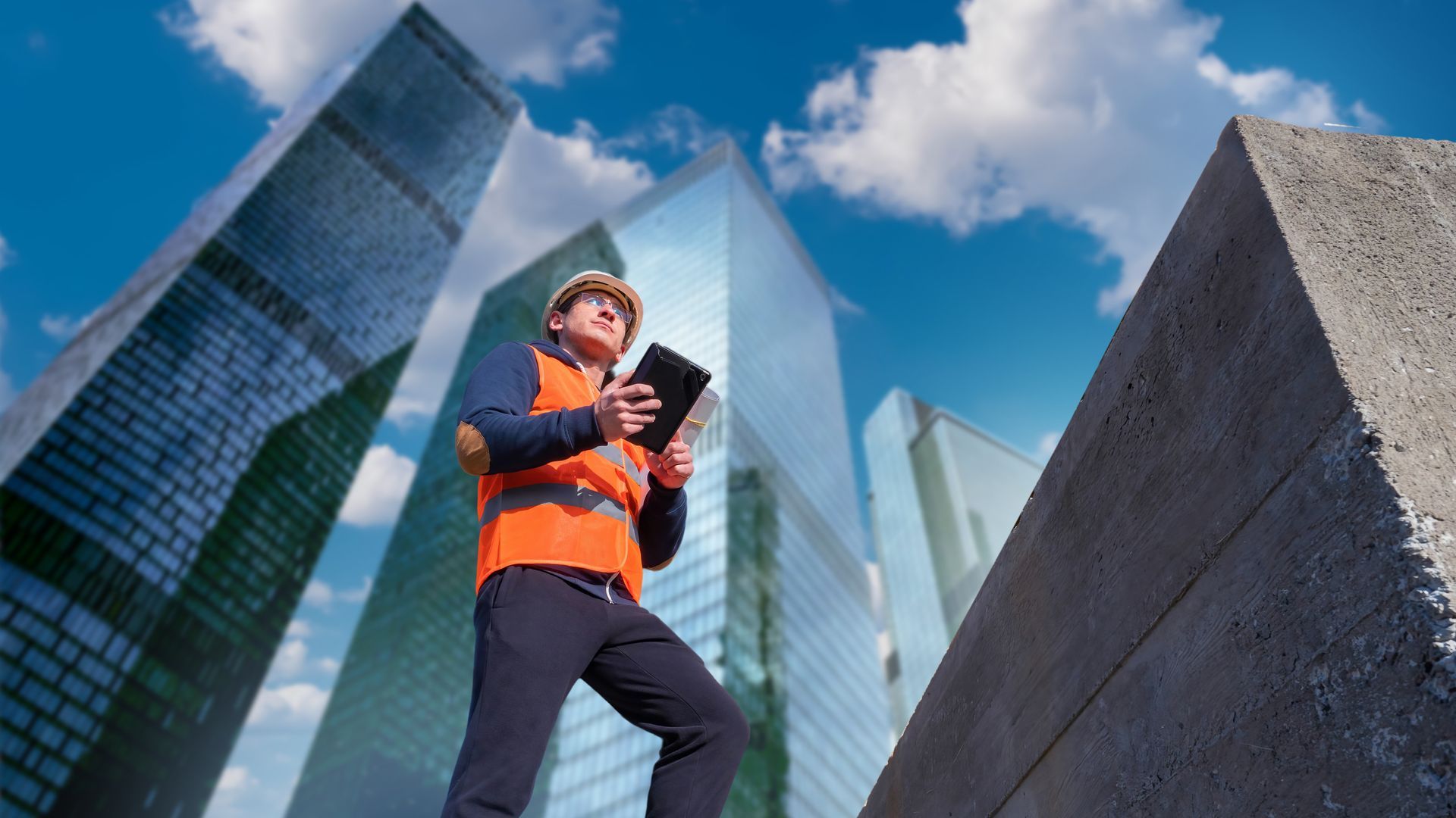 Commercial building contractor reviewing construction plans on a job site.