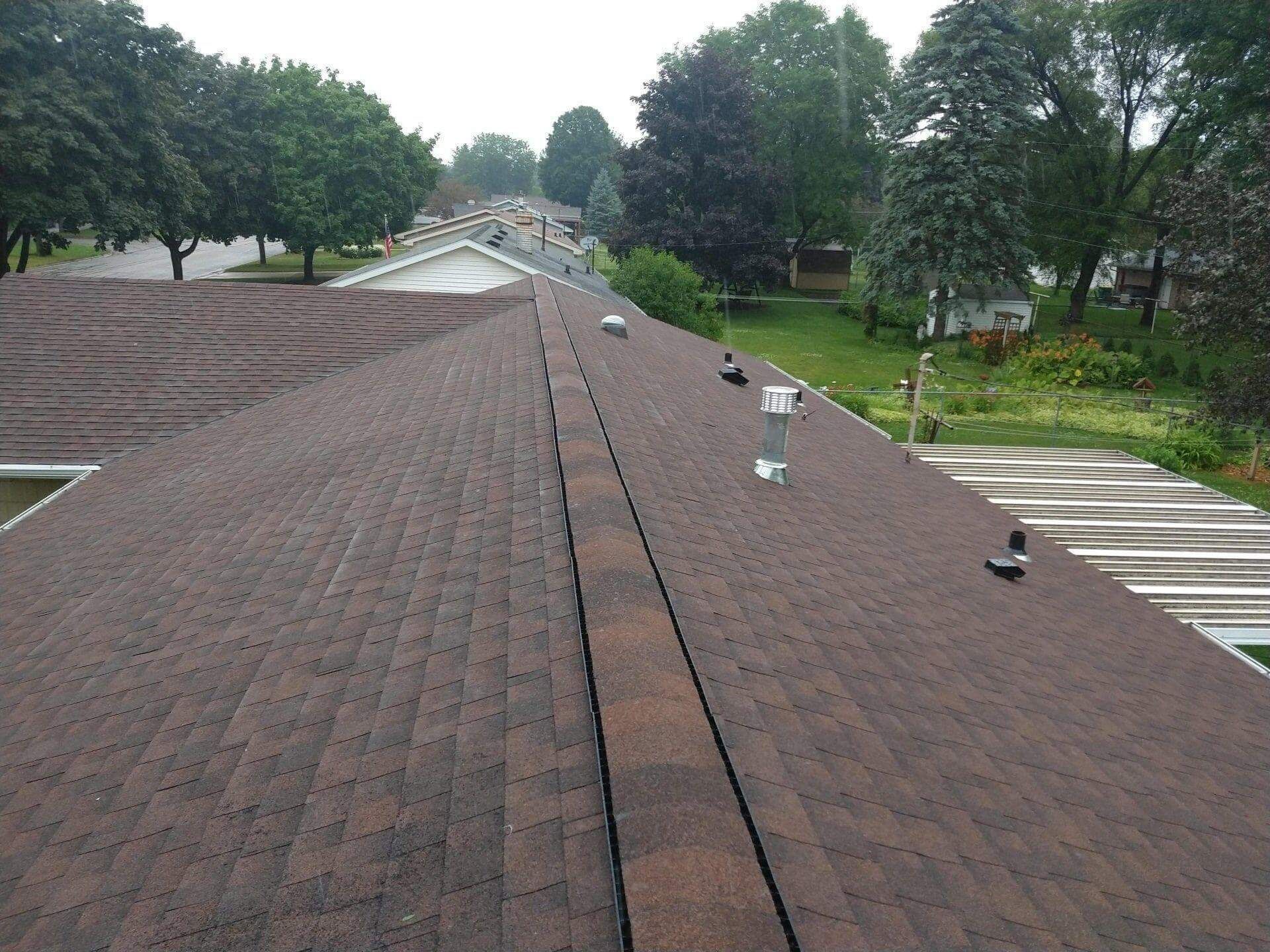 The roof of a house has a chimney on it