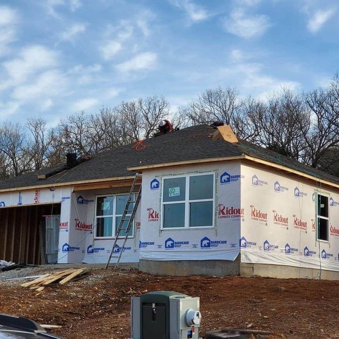 a house that is being built with a ladder in front of it