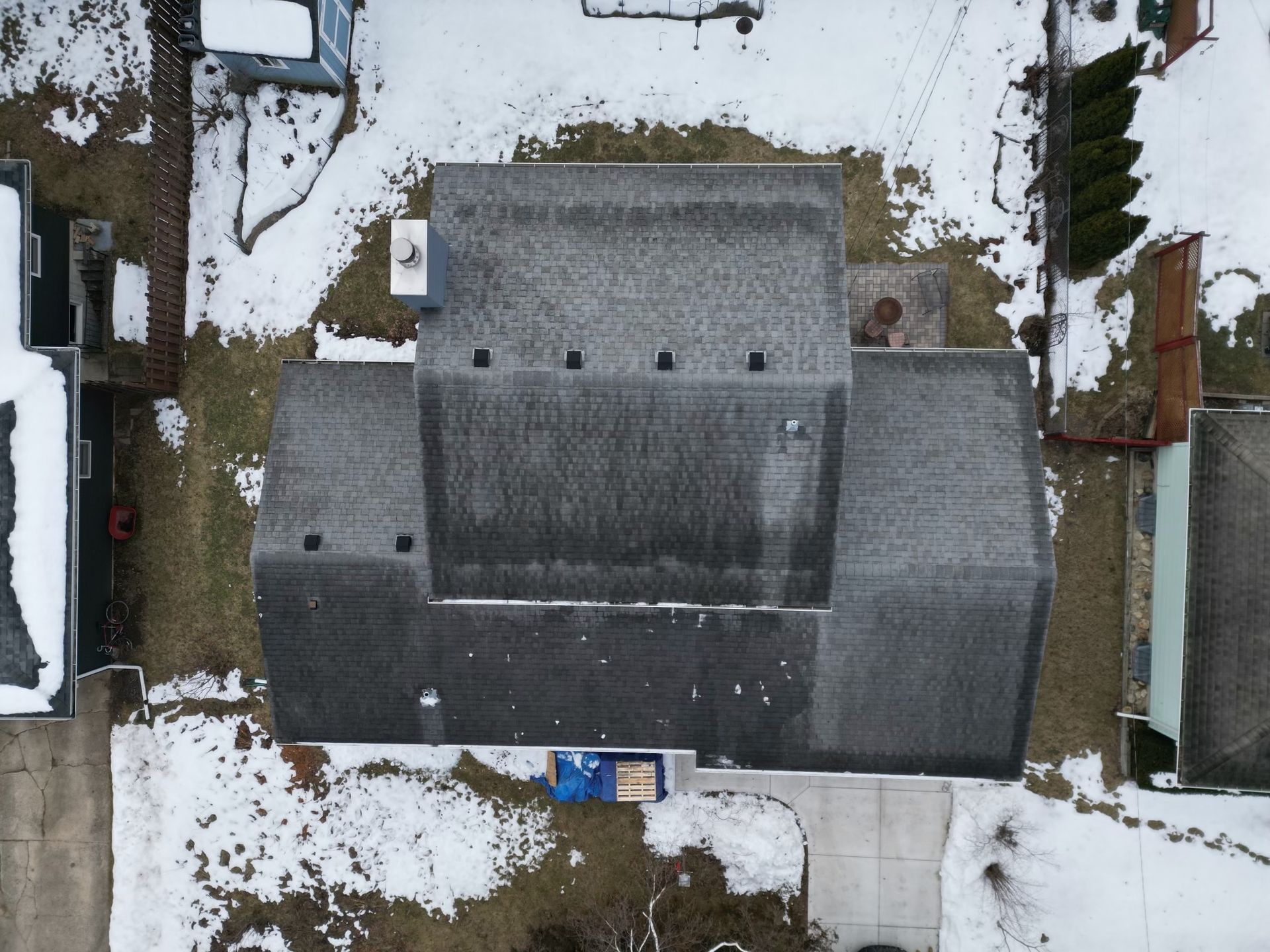 An aerial view of a house with snow on the ground
