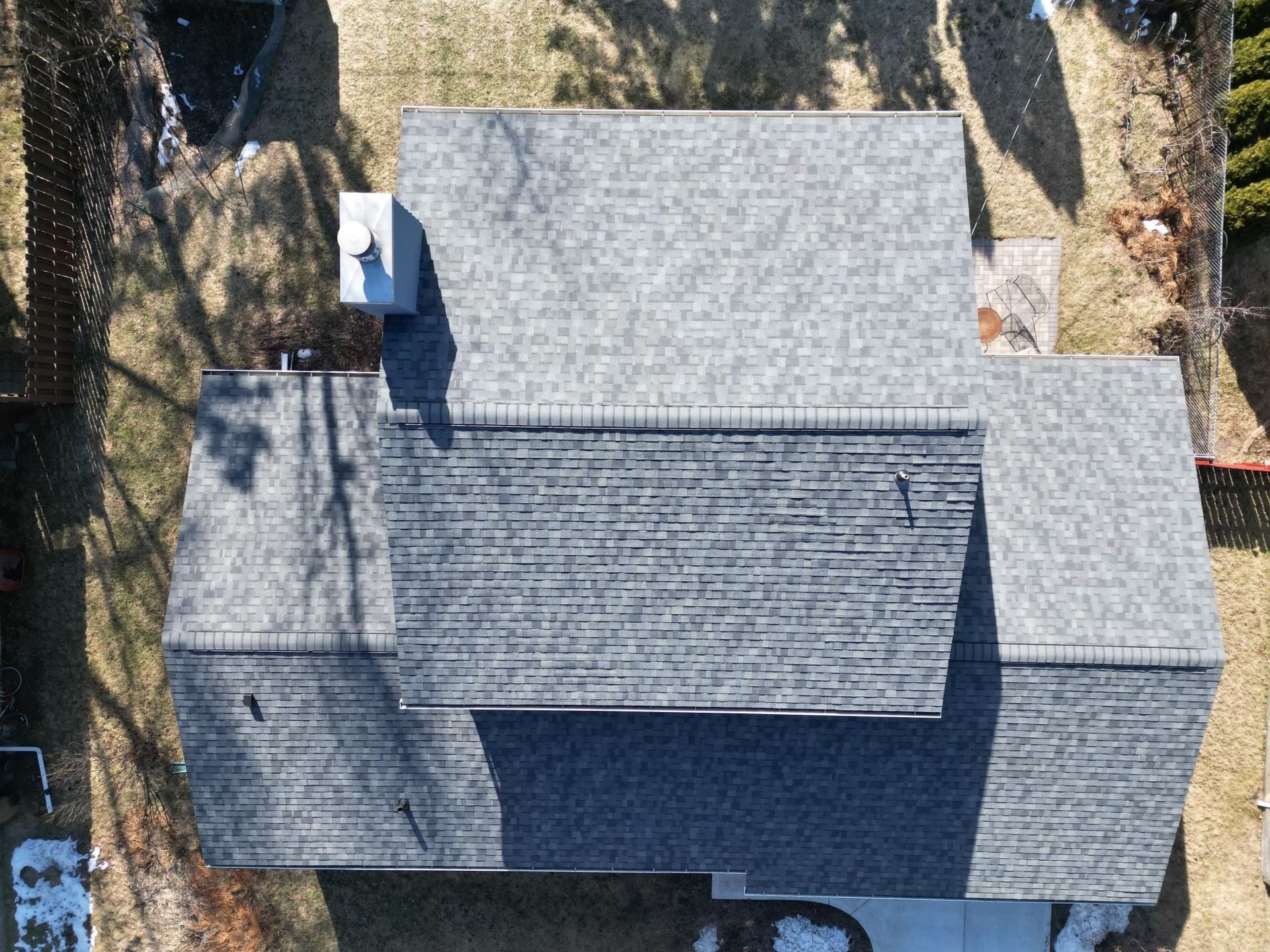 An aerial view of a house with a gray roof.