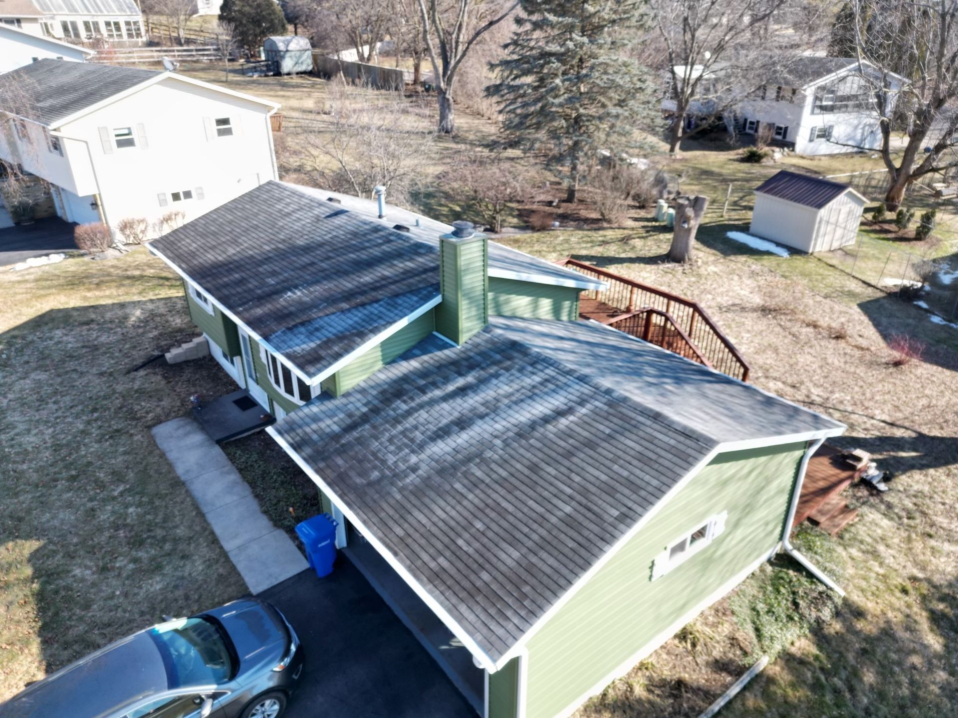 An aerial view of a house with a car parked in front of it.