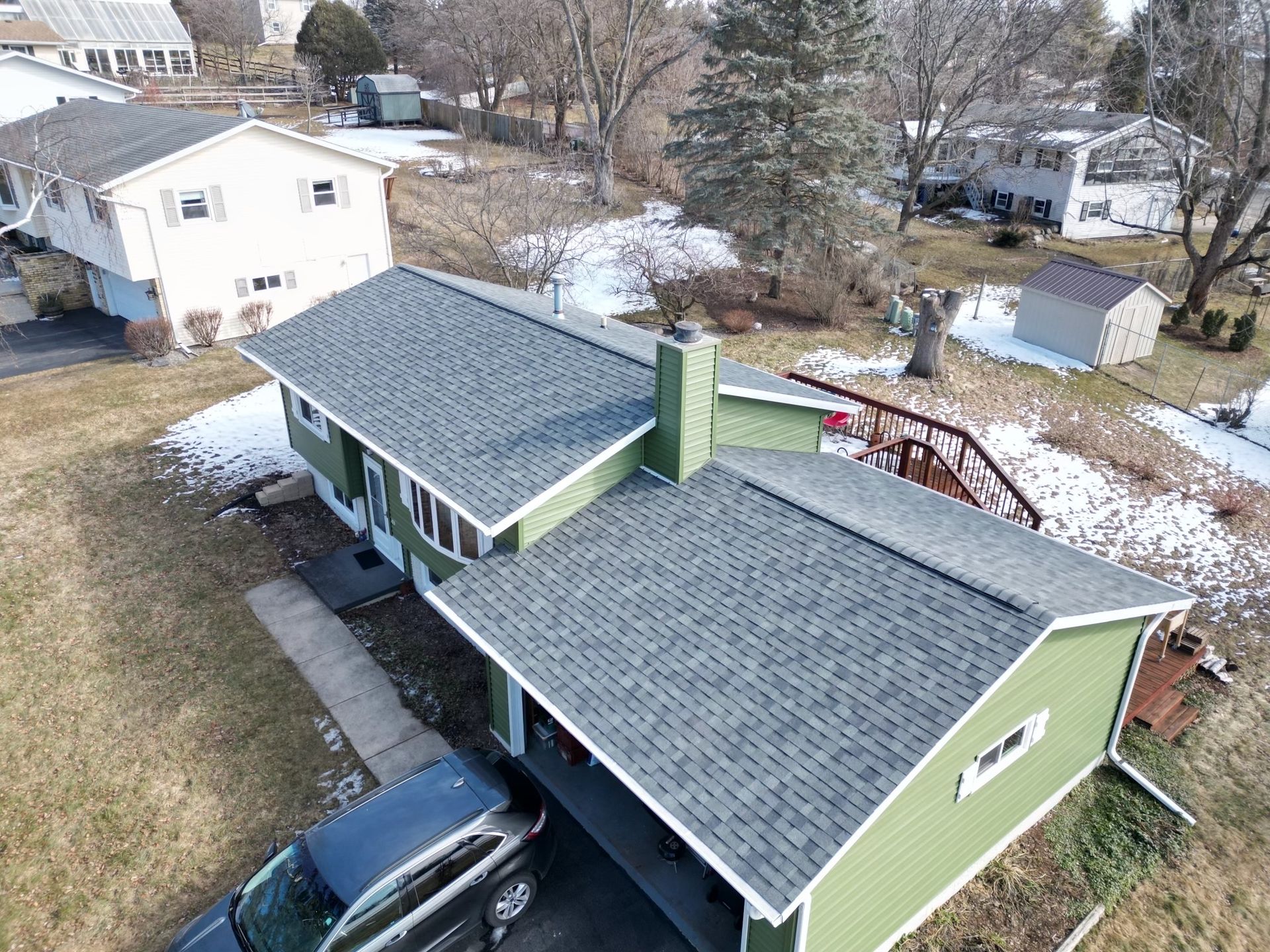 An aerial view of a house with a car parked in front of it.