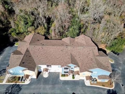 An aerial view of a large building surrounded by trees